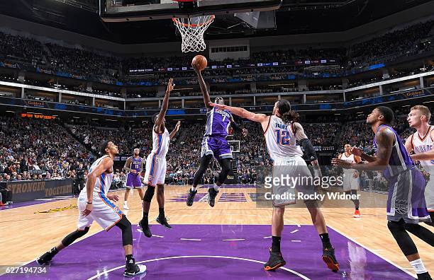 Darren Collison of the Sacramento Kings shoots a layup against Jerami Grant of the Oklahoma City Thunder on November 23, 2016 at Golden 1 Center in...