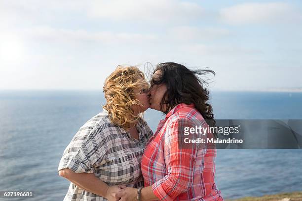 two woman kissing - fat lesbian stock pictures, royalty-free photos & images