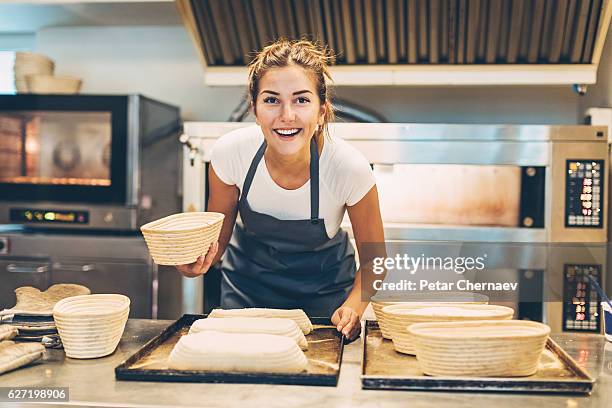 busy morning in the bakery - young cook imagens e fotografias de stock