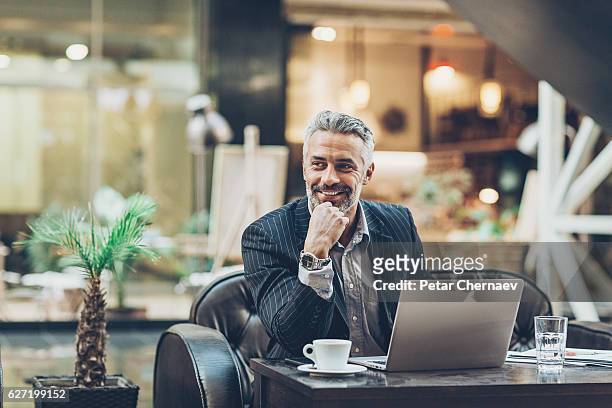 mature businessman working in comfort - chief executive officer stock pictures, royalty-free photos & images