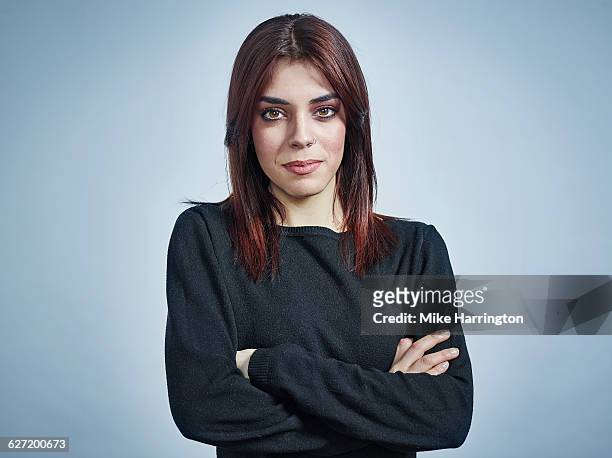 portrait of young female with arms crossed - nose piercing stock pictures, royalty-free photos & images