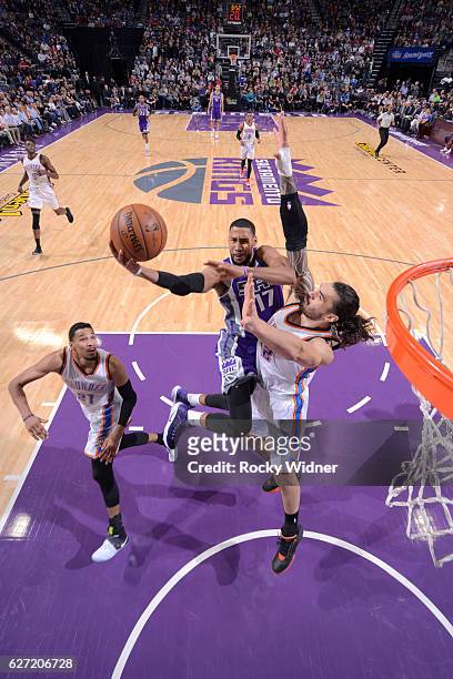 Garrett Temple of the Sacramento Kings shoots a layup against Steven Adams of the Oklahoma City Thunder on November 23, 2016 at Golden 1 Center in...
