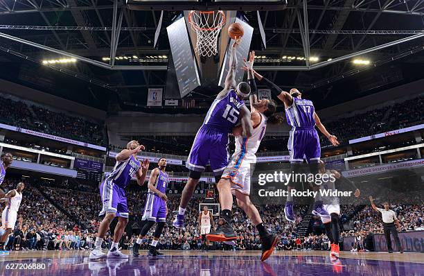 DeMarcus Cousins and Garrett Temple of the Sacramento Kings rebound against Steven Adams of the Oklahoma City Thunder on November 23, 2016 at Golden...