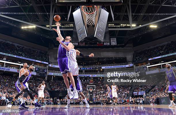 Kosta Koufos of the Sacramento Kings rebounds against Enes Kanter of the Oklahoma City Thunder on November 23, 2016 at Golden 1 Center in Sacramento,...