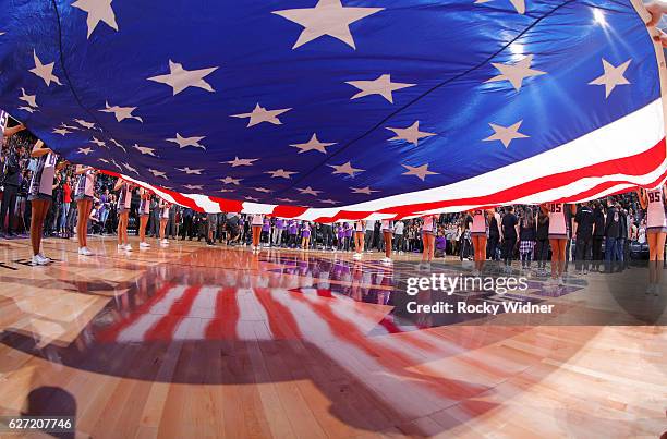 The Sacramento Kings dance team holds up the American flag during the national anthem of the game against the Oklahoma City Thunder on November 23,...
