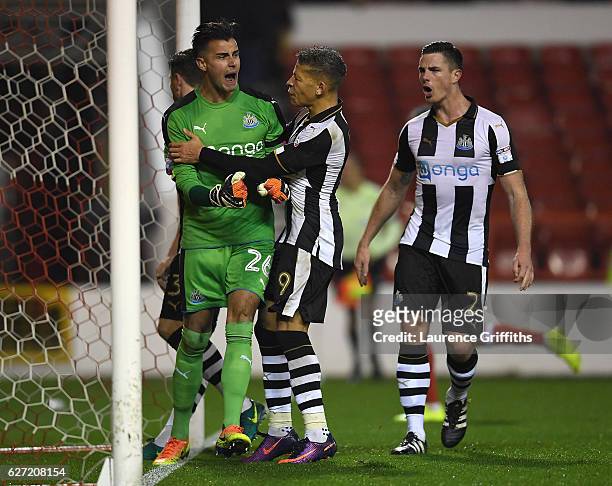 Dwight Gayle of Newcastle United congratulates Karl Darlow on saving a penalty of Nicklas Bendtner of Nottingham Forest during the Sky Bet...