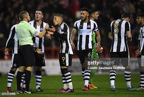 Dwight Gayle of Newcastle United argues with Referee Stephen Martin over the dismissal of Paul Dummett during the Sky Bet Championship match between...
