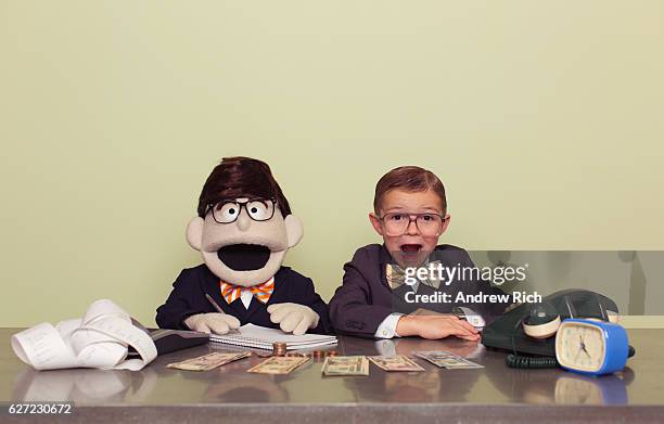 young boy accountant and puppet associate - fun calculator stockfoto's en -beelden