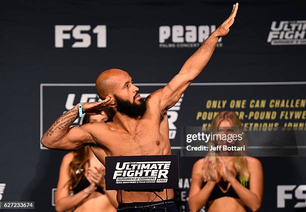 Flyweight champion Demetrious Johnson steps onto the scale during the TUF Finale weigh-in in the Palms Resort & Casino on December 2, 2016 in Las...