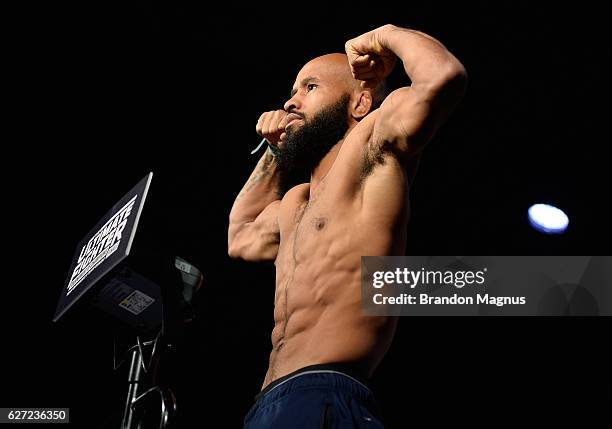 Flyweight champion Demetrious Johnson steps onto the scale during the TUF Finale weigh-in in the Palms Resort & Casino on December 2, 2016 in Las...