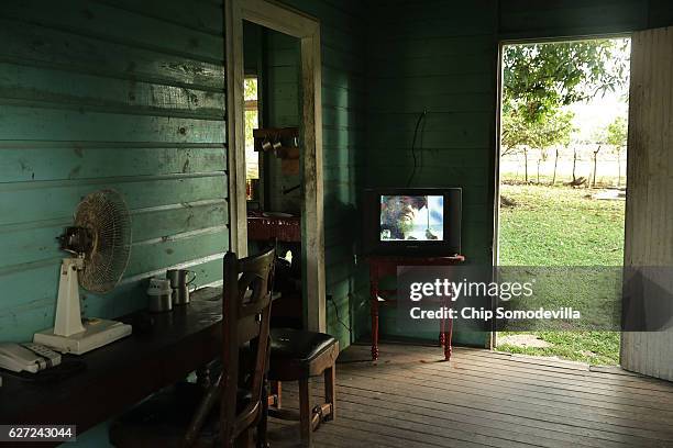 Images of former Cuban President Fidel Castro appear on a small television in the house used by the staff of the museum that preserves Castro's...