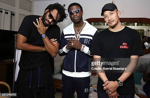 Public School designer Maxwell Osborne, rapper Gucci Mane and Public School designer Dao-Yi Chow pose for photos at Public School And The Confidante...