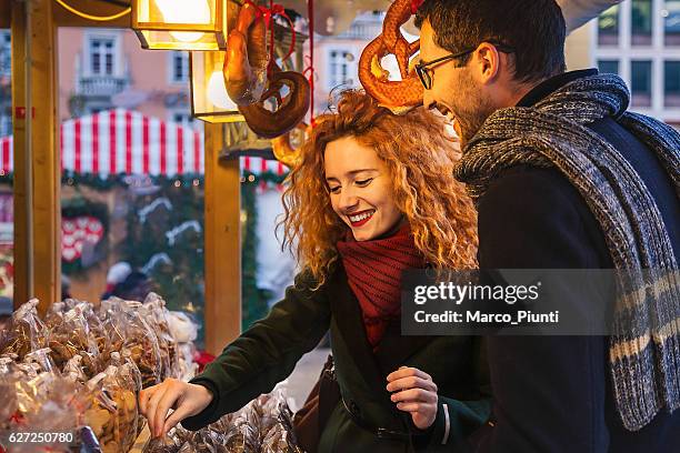 young couple in the city during christmas - bolzano stock pictures, royalty-free photos & images