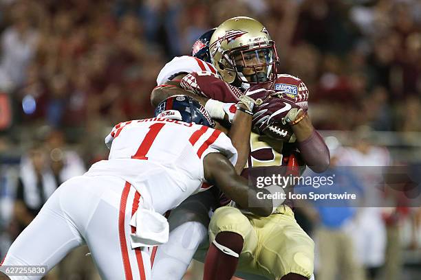 Florida State Seminoles wide receiver Travis Rudolph is tackled by Mississippi Rebels defensive back Tony Bridges and Mississippi Rebels defensive...