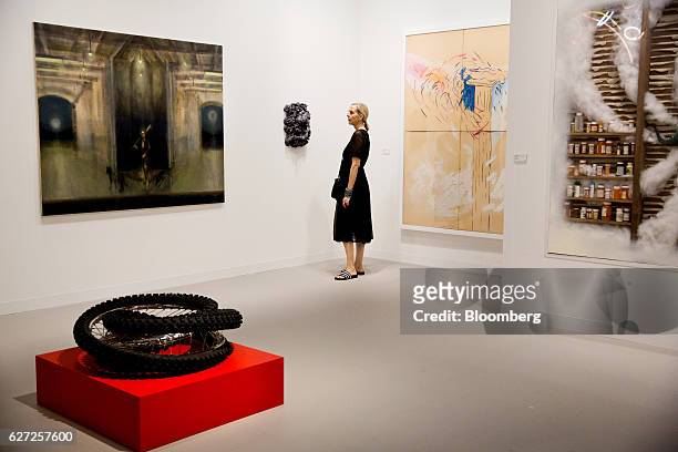 Visitor looks at various art installations on display during Art Basel Miami Beach in Miami, Florida, U.S., on Friday, Dec. 2, 2016. Politics is...