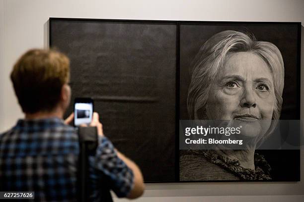 Visitor uses a smartphone to photograph a graphite portrait of Hillary Clinton, former 2016 Democratic presidential nominee, by Karl Haendel on...