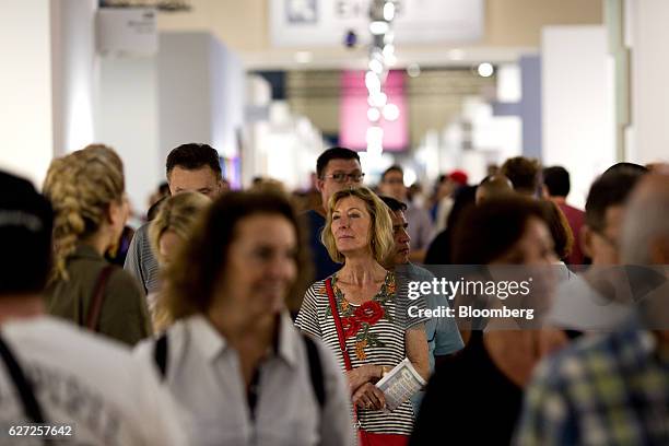 Visitors walk through Art Basel Miami Beach in Miami, Florida, U.S., on Friday, Dec. 2, 2016. Politics is prevalent at Art Basel this week, where...