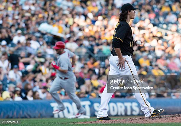 Pittsburgh Pirates starting pitcher Jeff Locke reacts as St. Louis Cardinals first baseman Matt Adams rounds the bases after hitting a two run home...