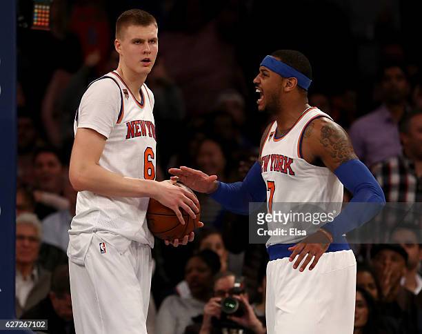 Kristaps Porzingis of the New York Knicks is congratulated by teammate Carmelo Anthony after Porzingis blocked a shot in the fourth quarter against...