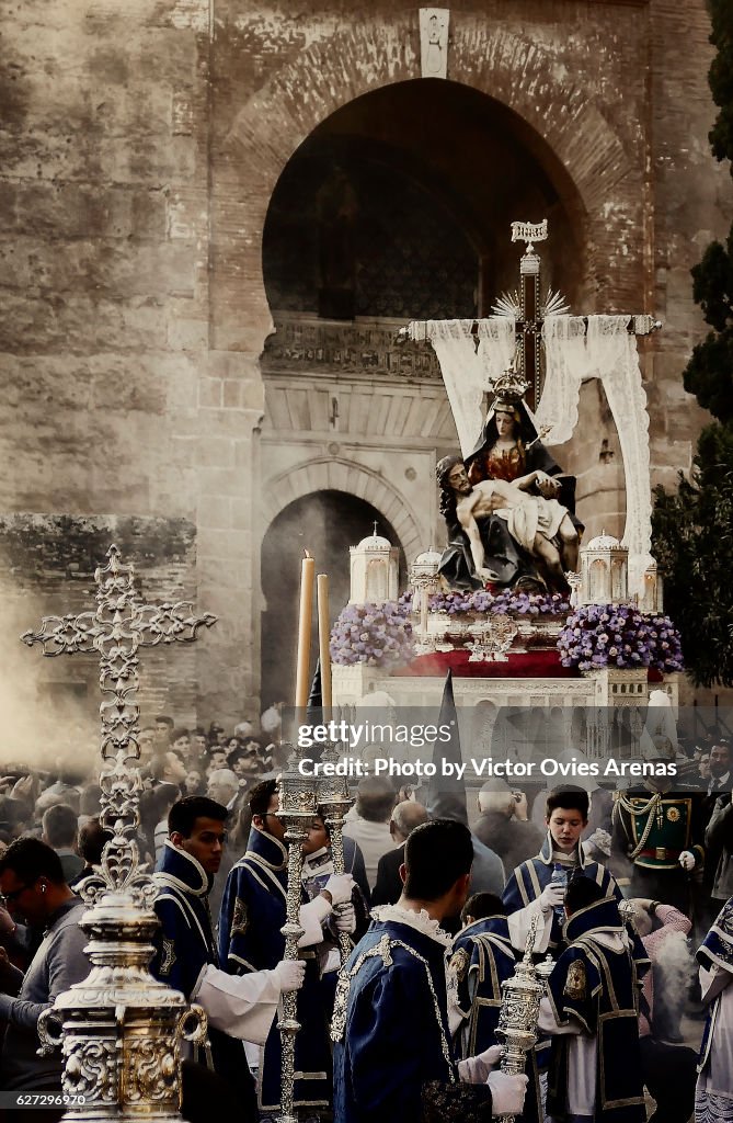 Float of Our Lady of the Alhambra and marching band outside the Alhambra's Puerta de la Justicia, for their annual Easter procession on Holy Saturday in Granada, Andalucia, Spain