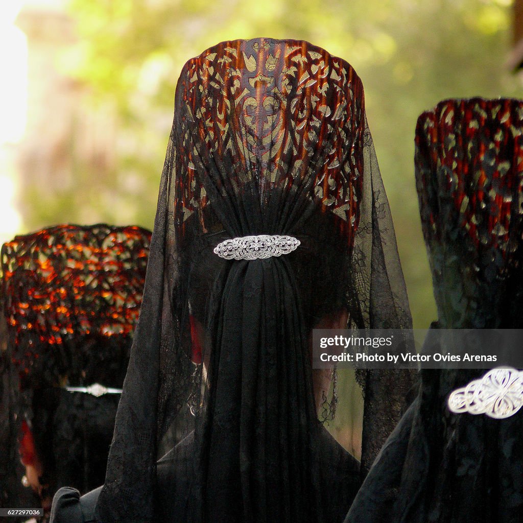 Women wearing Spanish traditional combs "peinetas" during Easter in Granada, Andalucia, Spain