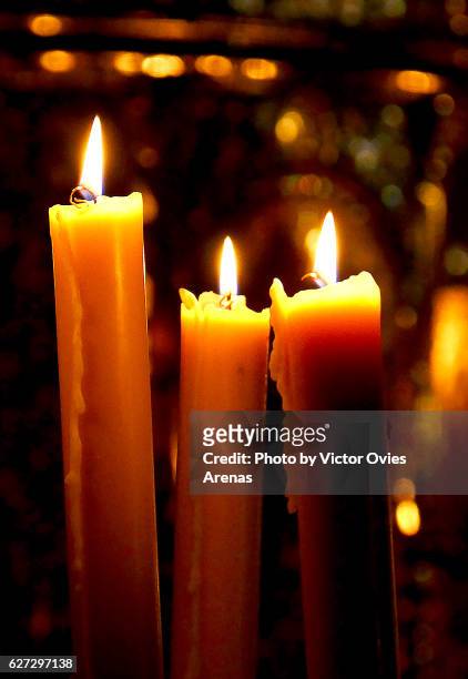 candles lit in a church in granada, spain - easter religious stock pictures, royalty-free photos & images