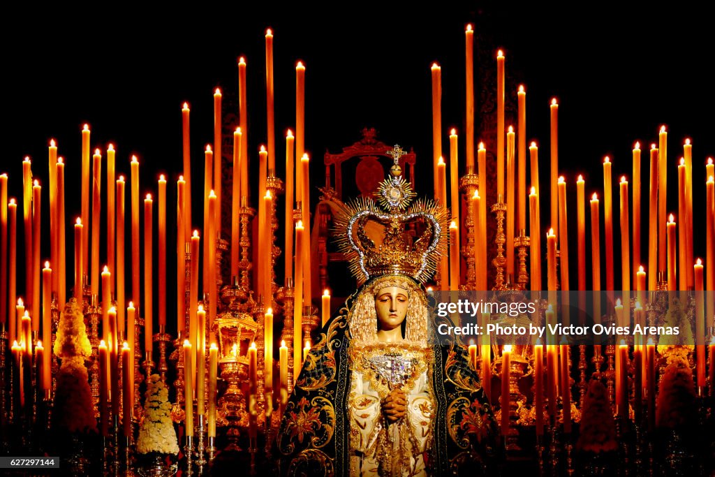 Virgin Mary surrounded by candles in a church in the centre of Granada, Andalusia, Spain