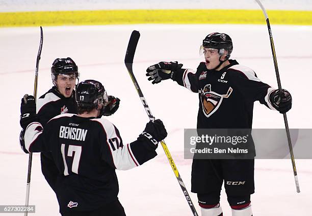 Dylan Plouffe of the Vancouver Giants celebrates his game-winning goal against the Brandon Wheat Kings with teammates James Malm and Tyler Benson...