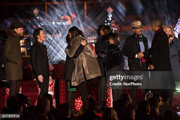 President Barack Obama and the first family, join the featured performers onstage at the end of the 94th Annual National Christmas Tree Lighting...