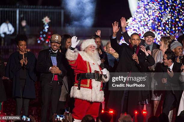 President Barack Obama and the first family, join the featured performers onstage at the end of the 94th Annual National Christmas Tree Lighting...