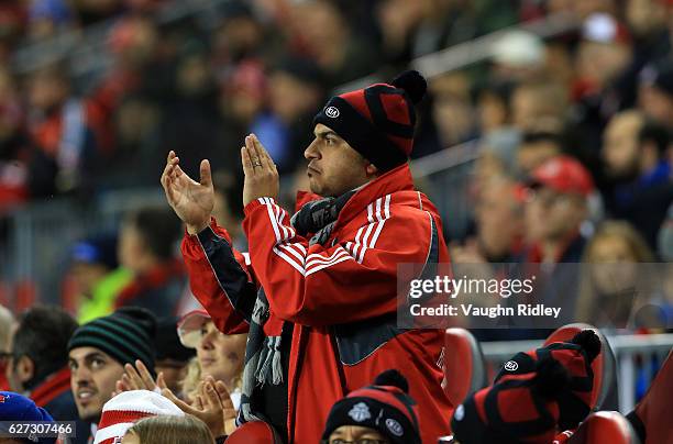 Fan applauds during the first half of the MLS Eastern Conference Final, Leg 2 game between Montreal Impact and Toronto FC at BMO Field on November...