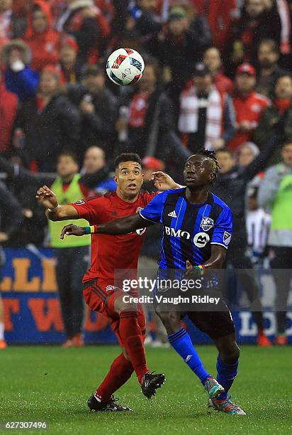 Justin Morrow of Toronto FC battles for the ball with Dominic Oduro of Montreal Impact during the first half of the MLS Eastern Conference Final, Leg...