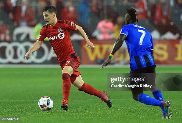 Will Johnson of Toronto FC battles for the ball with Dominic Oduro of Montreal Impact during the first half of the MLS Eastern Conference Final, Leg...