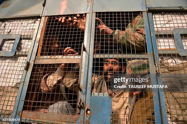 Members of the All Jammu and Kashmir Handicapped Association shout anti-government slogans from a police vehicle after they were detained during a...