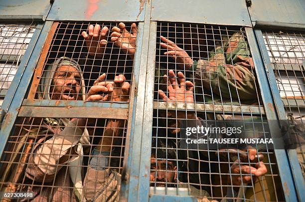 Members of the All Jammu and Kashmir Handicapped Association shout anti-government slogans from a police vehicle after they were detained during a...