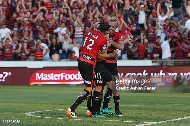 Brendon Santalab, Mitch Nichols and Scott Neville of the Wanderers celebrate a goal during the round nine A-League match between Central Coast...