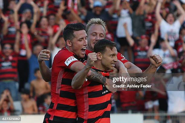 Brendon Santalab, Mitch Nichols and Scott Neville of the Wanderers celebrate a goal during the round nine A-League match between Central Coast...