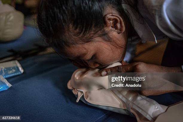 Student practices CPR on a mannequin during a water safety and drowning prevention class on Monday, November 28, 2016 in Prey Veng province