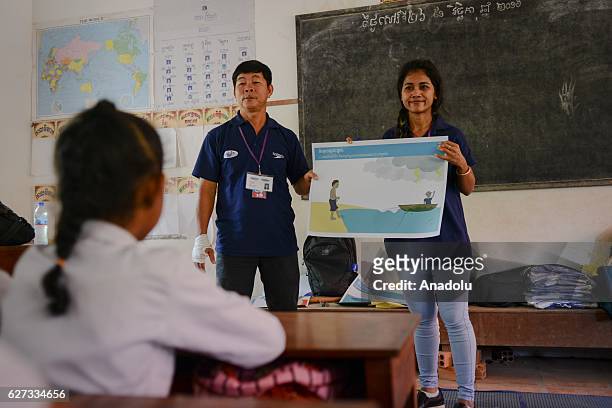 Keo Sopheap and Chan Sovanna from Safety When It Matters Cambodia teach children the dangers of water during a safety and drowning prevention class...