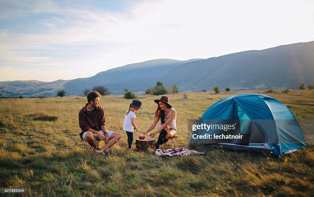 Young people camping with a baby girl