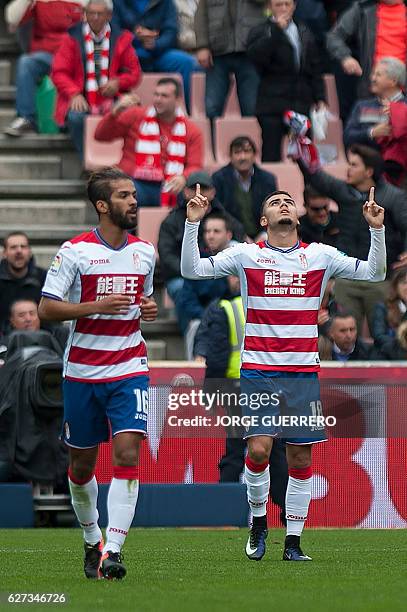 Granada's Belgian midfielder Andreas Pereira celebrates a goal beside Granada's Moroccan midfielder Mehdi Carcela during the Spanish league football...