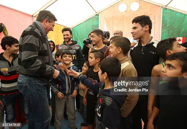 Slovenian President Borut Pahor meets Syrian refugee children during their exercise at Makani's gym, run by Unicef, during his visit to the Zaatari...