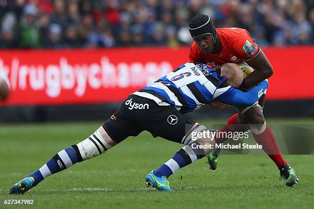 Maro Itoje of Saracens is tackled by Matt Garvey of Bath during the Aviva Premiership match between Bath Rugby and Saracens at the Recreation Ground...