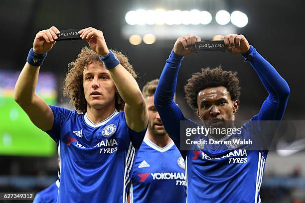 Willian of Chelsea holds up the black armband to commemorate the victims of the plane crash involving the Brazilian club Chapecoense along with his...