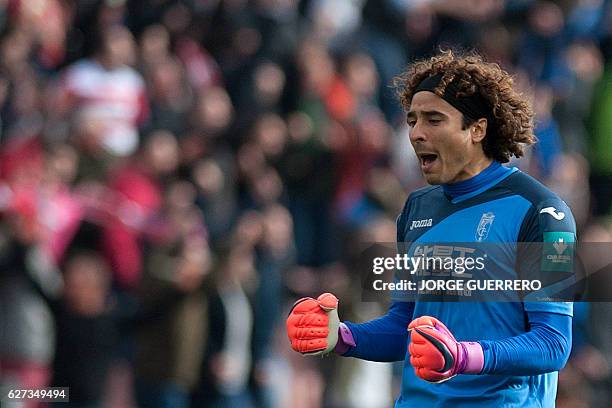 Granada's Mexican goalkeeper Guillermo Ochoa celebrates a goal during the Spanish league football match Granada CF vs Sevilla FC at Nuevo Los...