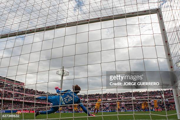 Sevilla's French forward Wissam Ben Yedder shoots a penalty kick to score a goal during the Spanish league football match Granada CF vs Sevilla FC at...