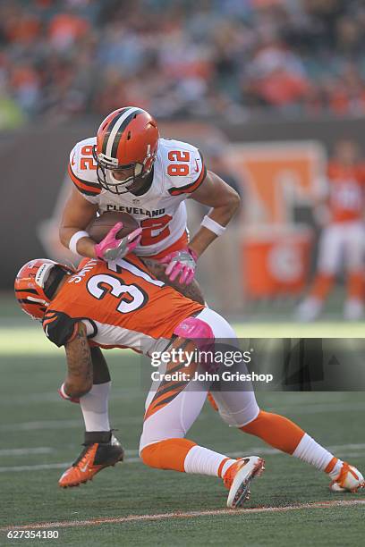 Gary Barnidge of the Cleveland Browns runs the football upfield against Derron Smith of the Cincinnati Bengals during their game at Paul Brown...