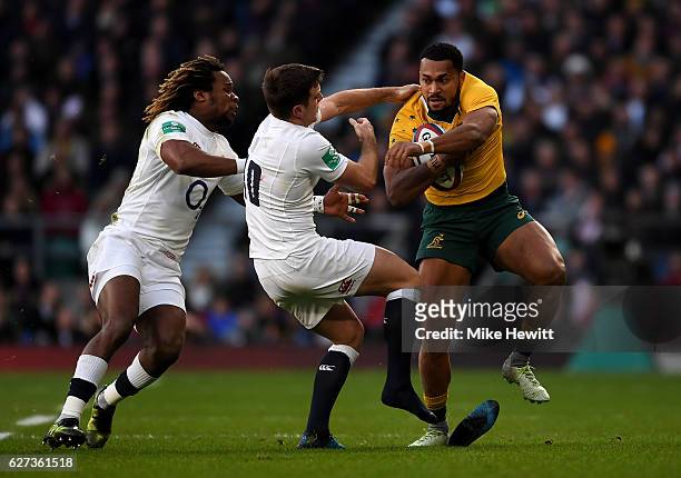 Sefanaia Naivalu of Australia is tackled by Marland Yarde of England and George Ford of England during the Old Mutual Wealth Series match between...