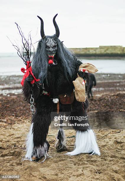 Participant dresses as the folklore figure, Krampus, during a charity event on December 3, 2016 in Whitby, United Kingdom. The Krampus is a horned,...