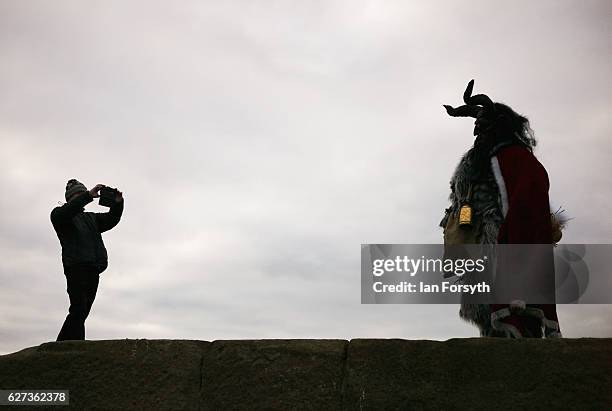 Lawerence Mitchell from Whitby dresses as the folklore figure, Krampus, and poses for pictures ahead of a charity event on December 3, 2016 in...